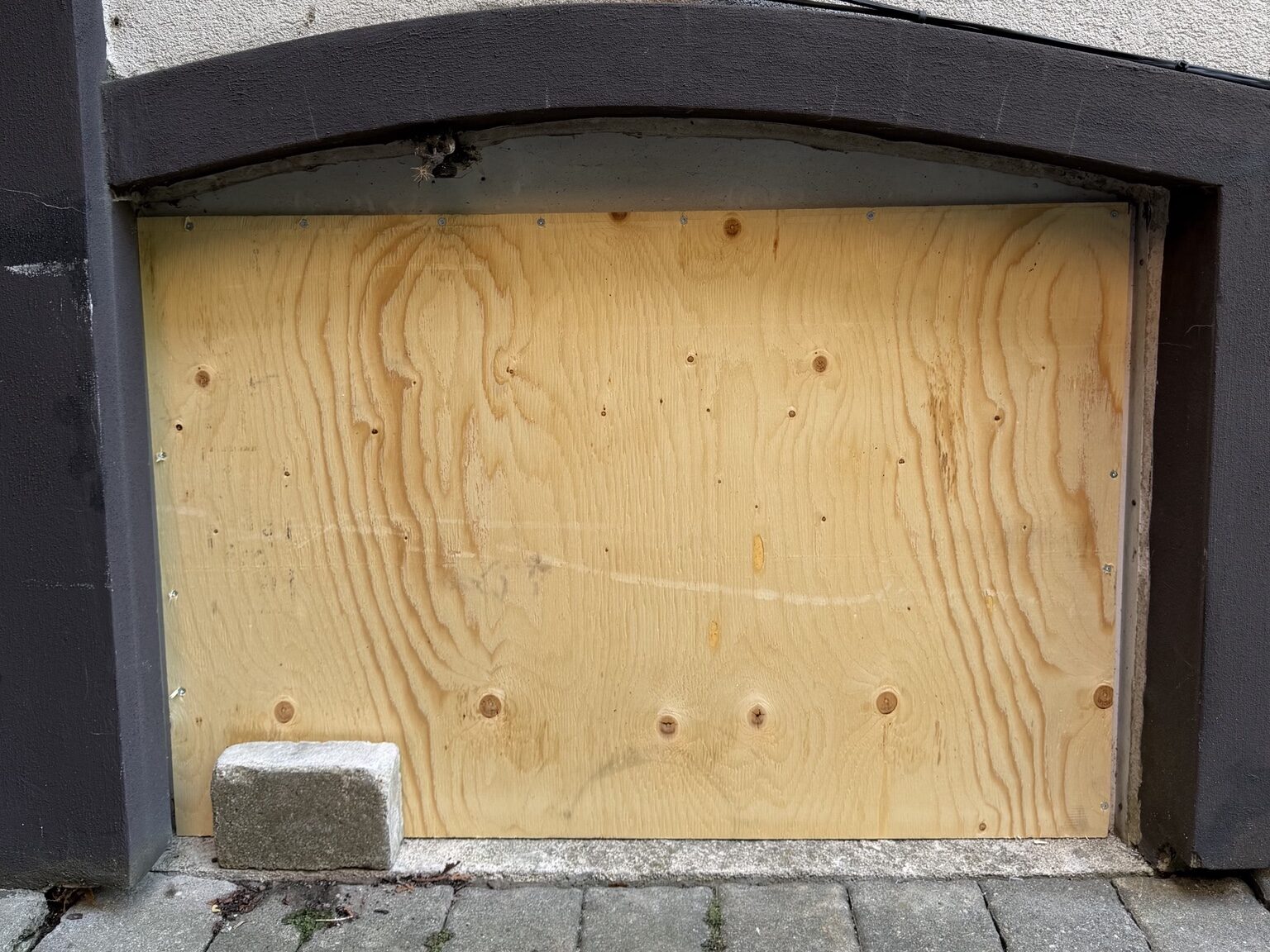 Etobicoke basement window secured with plywood board-up