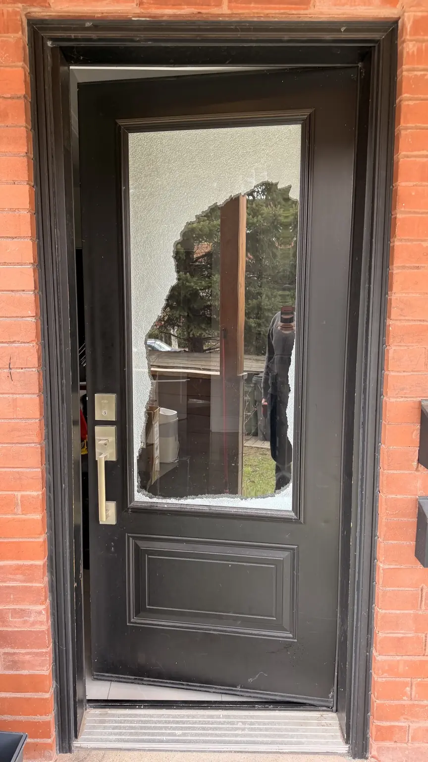 Toronto residential entry door with a large broken glass opening