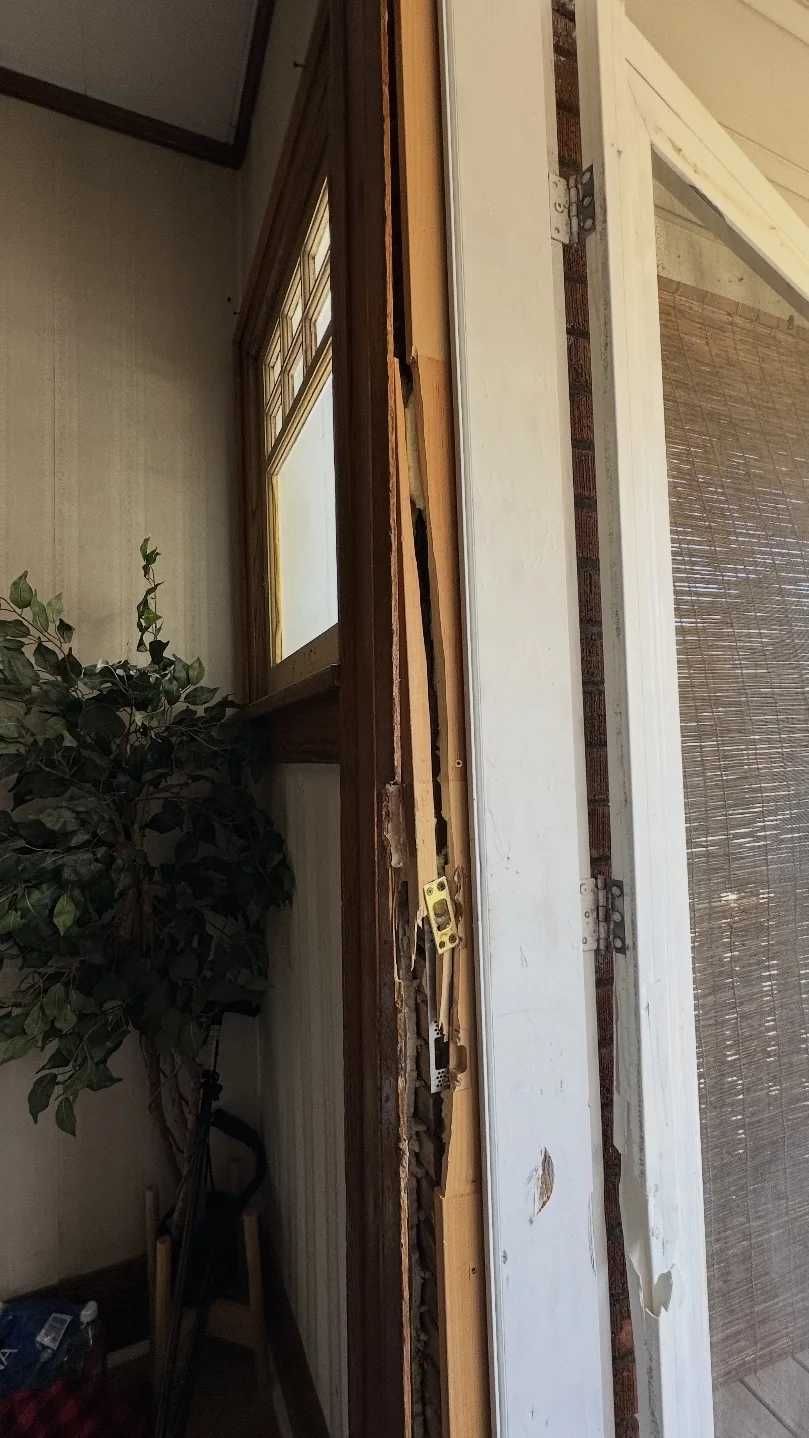 Split residential door jamb and damaged strike area requiring door frame repair